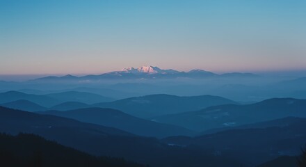 Obraz premium The majestic mountains at dawn, bathed in the soft hues of blue and twilight