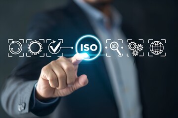A person is selecting the ISO icon with their finger, showing the concept of standard or quality process on a dark background.