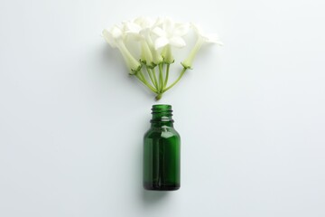 Plakat Bottle of essential oil and jasmine flowers on white background, flat lay