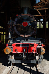 Close-up of steam locomotive front with red buffer beam, coupler