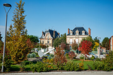 Historic building and mansions amid trees in French countryside