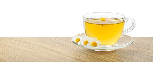Delicious chamomile tea in glass cup and fresh flowers on wooden table against white background