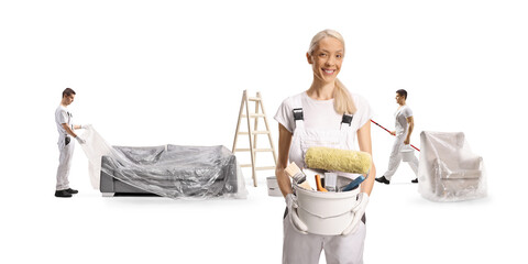 House painters covering furniture with a plastic drop cloth