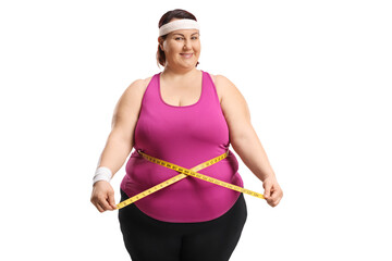 Overweight woman standing and measuring waist with a tape