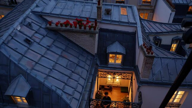 Cozy rooftop apartment with flowers and warm lighting, nestled among the parisian rooftops during the evening, creating a charming urban scene