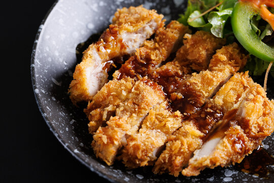 Gourmet meal featuring delicious fried chicken wings and crispy fried chicken with rice served on a white plate as a hot cooked dish of poultry cuisine with savory sauce