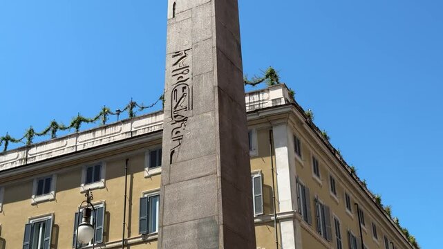 The Obelisk of Montecitorio in Rome, an ancient Egyptian monument brought to the city by Augustus, standing tall as a symbol of history and Roman imperial power.

