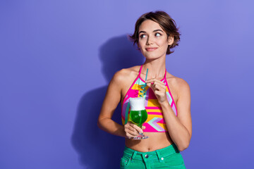 Photo of gorgeous girl wear bright clothes hold delicious drink look information banner blank space isolated on purple color background
