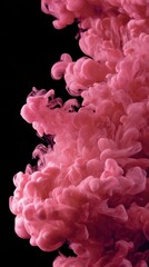 Obraz premium A stunning image of pink smoke clouds isolated on black background.