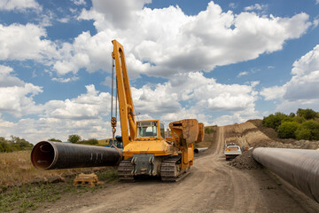 Large Pipeline Construction. Heavy Machinery Installing Underground Gas or Oil Pipeline. Infrastructure Development and Energy Industry Concept. Industrial Infrastructure Project