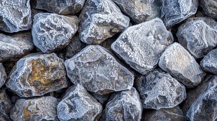A pile of rocks with frost on them, arranged in a pile with a white background.
