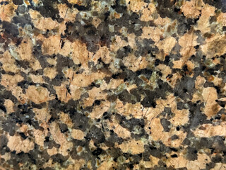 Close up of weathered random red brown granite with black grains. Natural open pore red granite stone texture honed for outdoor flooring. Seamless background texture.