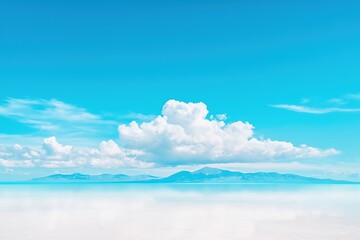 Obraz premium Reflective Salt Flat with Distant Mountains Under Blue Sky and Clouds - Mirror Horizon - Space for Text