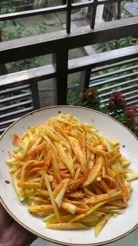 peeled mangoes in a bowl. Fresh sweet and sour fruits. Fresh raw green mango ready to be pickled or smashed. fresh young mango and leaf, tropical fruit. mango slice.