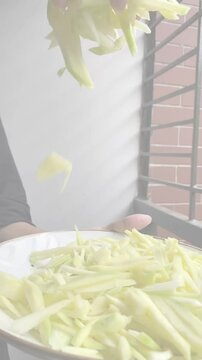 peeled mangoes in a bowl. Fresh sweet and sour fruits. Fresh raw green mango ready to be pickled or smashed. fresh young mango and leaf, tropical fruit. mango slice.
