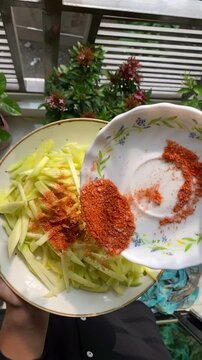 peeled mangoes in a bowl. Fresh sweet and sour fruits. Fresh raw green mango ready to be pickled or smashed. fresh young mango and leaf, tropical fruit. mango slice.