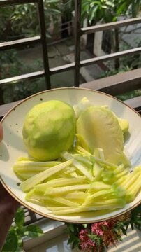 peeled mangoes in a bowl. Fresh sweet and sour fruits. Fresh raw green mango ready to be pickled or smashed. fresh young mango and leaf, tropical fruit. mango slice.