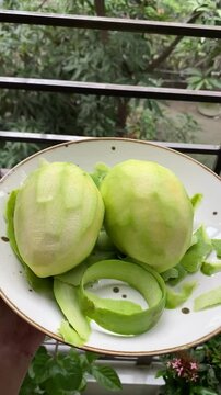 peeled mangoes in a bowl. Fresh sweet and sour fruits. Fresh raw green mango ready to be pickled or smashed. fresh young mango and leaf, tropical fruit. mango slice.