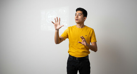 Man in yellow shirt gesturing at a virtual display