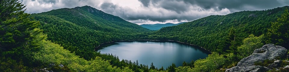 Fototapeta premium Tranquil mountain lake surrounded by lush evergreen trees under a cloudy sky