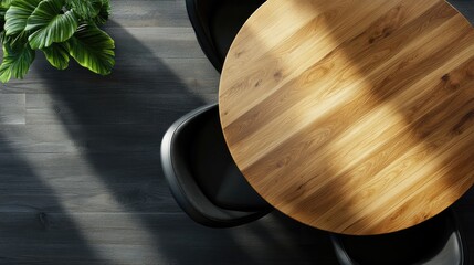 Top view of a round wooden table and black chair inside
