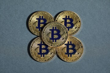 Cryptocurrency. Golden bitcoins on grey background, flat lay
