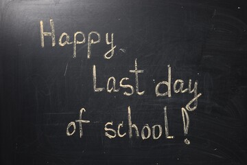 Fototapeta premium Phrase Happy Last Day of School with exclamation mark on blackboard