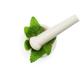 Fresh lemon balm leaves and pestle in mortar isolated on white, top view