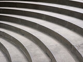 Curved concrete steps forming a semicircle in an urban environment