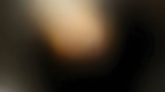 Blurry, out-of-focus image featuring a gradient of dark and light brown and beige tones transitioning into a dark background. The colors are soft and blended together.
