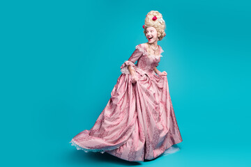 Full size photo of young aristocratic woman run look behind empty space wear baroque dress isolated on teal color background © deagreez