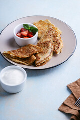 Sweet rye and whole grain crepes with strawberry and sour cream