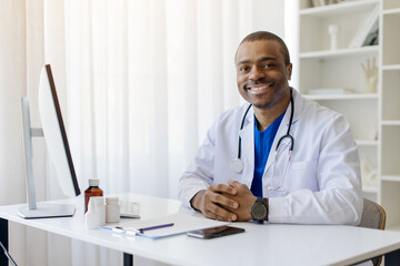 Portrait Of Smiling Black Doctor Man Posing At Workplace In Office, Confident Male Physician In...
