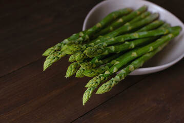 Close up of asparagus on wooden background