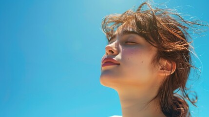 A low viewpoint depicts a young lady breathing in fresh air while closing her eyes against a sunny blue sky with text space, Generative AI.