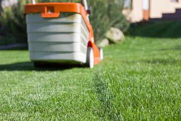 Lawnmower mowing the lawn. Selective focus.