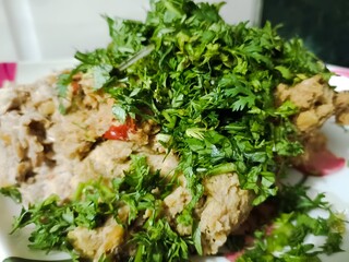 A close-up image of raw jackfruit kabab batter garnished with fresh coriander leaves, prepared for making vegetarian kababs. Ideal for food blogs, recipe books, or cooking websites.
