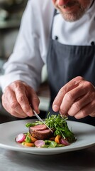 Chef meticulously arranging microgreens on a gourmet dish with sliced meat and colorful vegetables