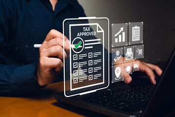 A person uses digital technology to approve a tax document on a virtual screen, symbolizing online tax filing and approval.
