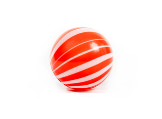 Red and white striped plastic ball, children's toy, isolated on white background