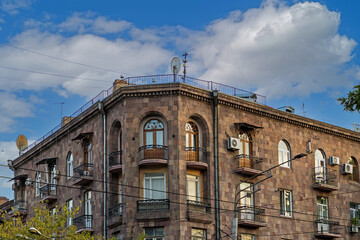 Old retro building with faded facade with closed widows