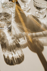 Crystal Cups and Amber Bottle in Soft Warm Lighting, Modern Minimalist Style