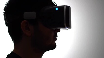 VR Glasses, A man in a virtual reality headset talks and moves his hands typing on a virtual keyboard. Excited mature senior man wearing using virtual reality metaverse VR glasses headset. video - Powered by Adobe