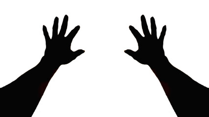 Obraz premium The silhouette of a pair of hands raised above the head as a sign of pleading or asking for help and the raised hands also give the appearance of appealing to God or asking for a blessing from God.