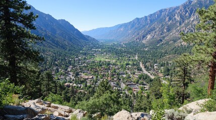 High-angle view of a valley town nestled amongst mountains.