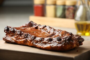 Delicious roasted pork ribs with spices on table, closeup