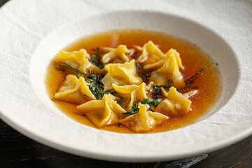 Portion of italian ravioli fagottini dumplings dish with sauce