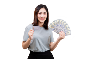 A woman holding a fan of US dollar bills in one hand and a credit card in the other, smiling at the camera.