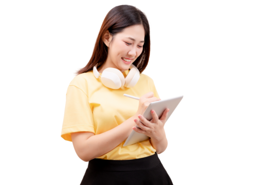 Young woman smiling while using a digital tablet and stylus, wearing headphones around her neck.