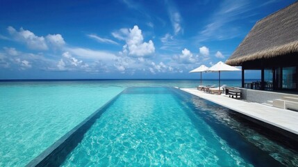 Fototapeta premium Luxurious beachfront villa with private pool and ocean view. 